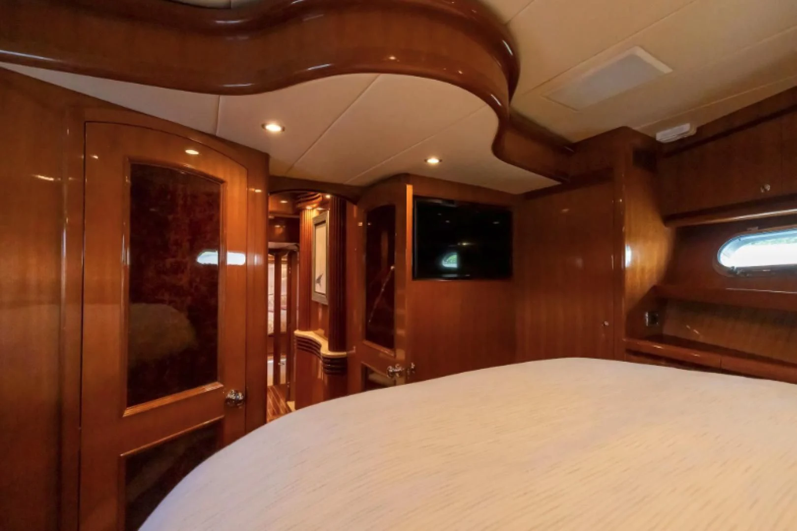a room with a bed and a television aboard WRITE SOON Yacht for Sale