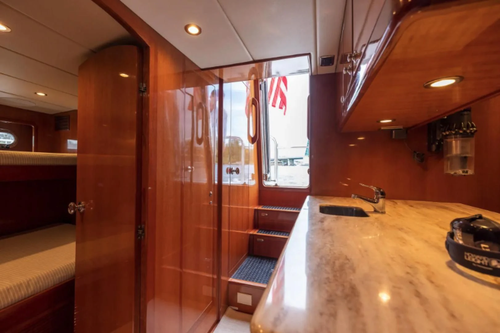 a bathroom with a countertop sink and a shower unit aboard WRITE SOON Yacht for Sale