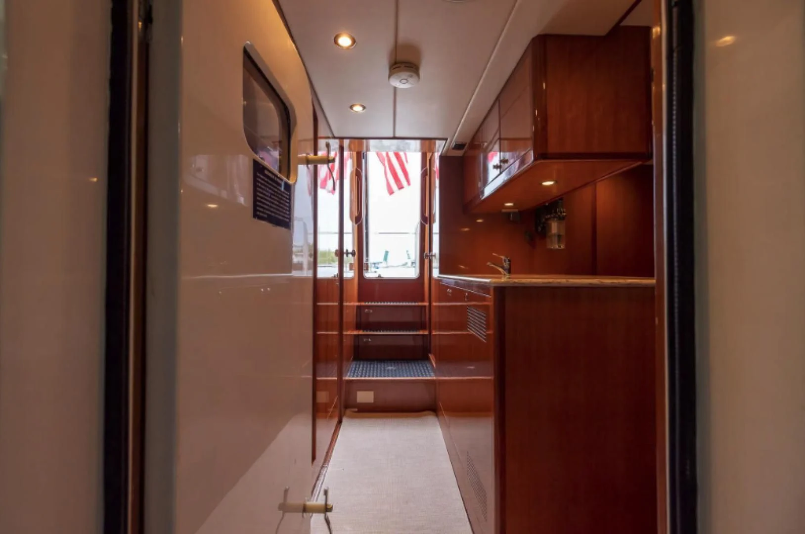 a hallway with wooden cabinets aboard WRITE SOON Yacht for Sale