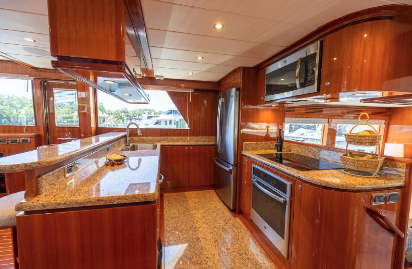 a kitchen with wooden cabinets aboard WRITE SOON Yacht for Sale