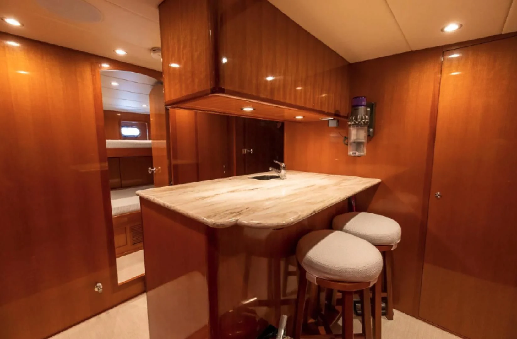 a kitchen with a table and stools aboard WRITE SOON Yacht for Sale