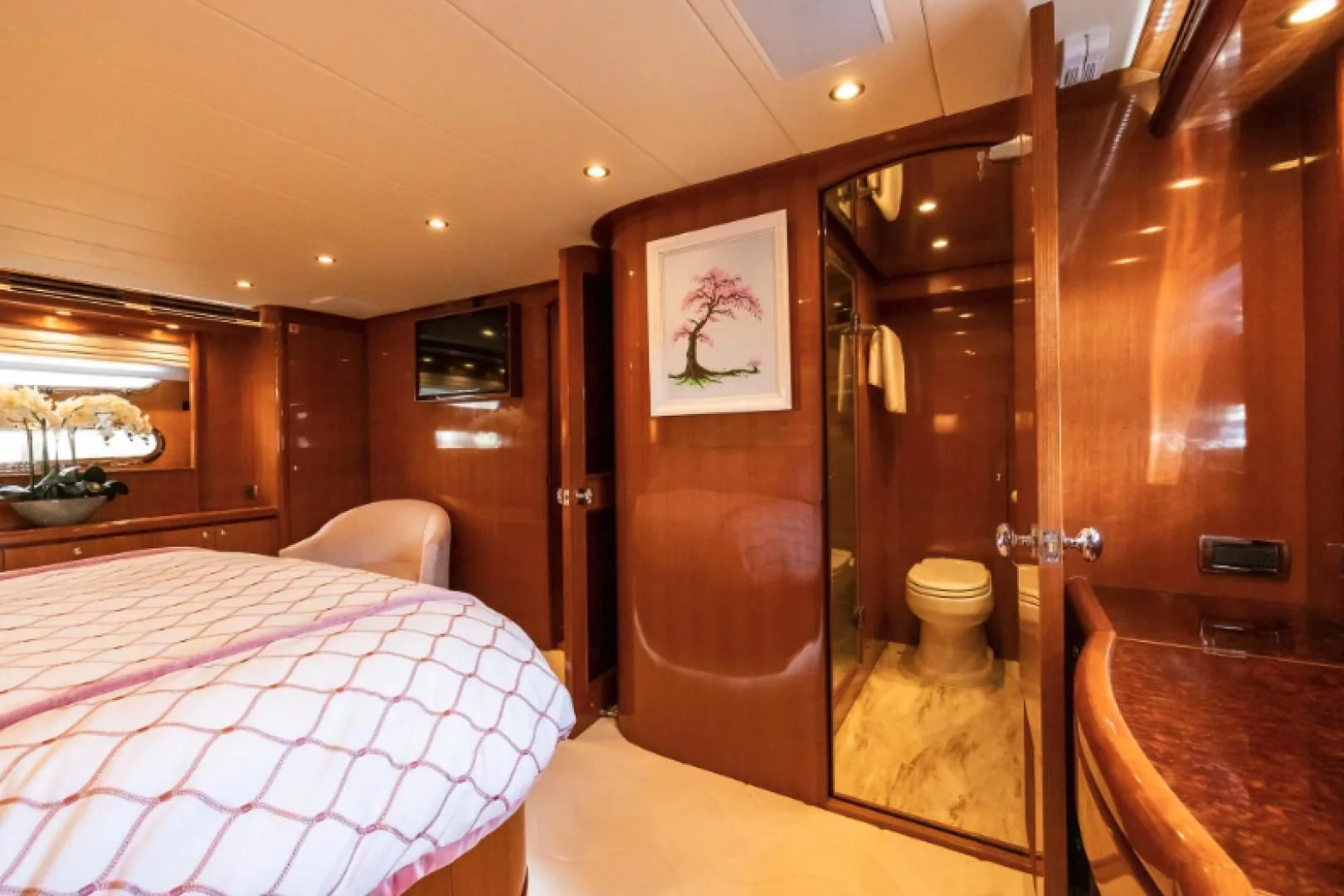 a bedroom with a bed and a mirror aboard WRITE SOON Yacht for Sale