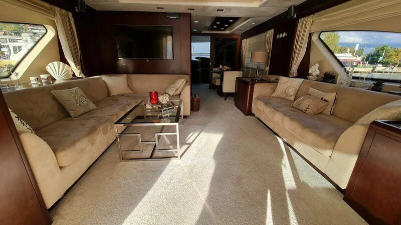 a living room with a couch and a coffee table aboard ABK Yacht for Sale
