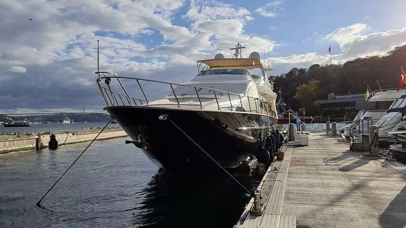 a boat docked at a pier aboard ABK Yacht for Sale