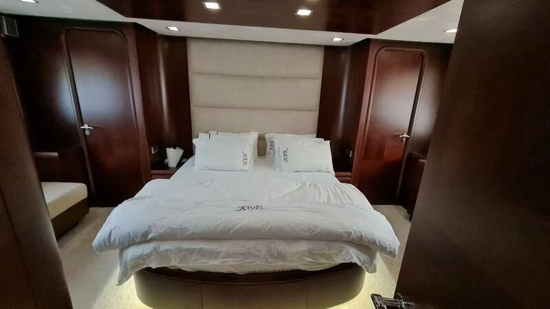 a bed with white sheets aboard ABK Yacht for Sale