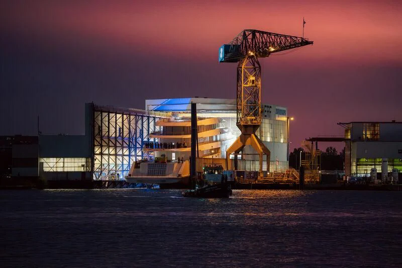 a large building with cranes aboard PI Yacht for Sale