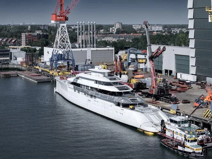 a large white ship docked aboard PI Yacht for Sale