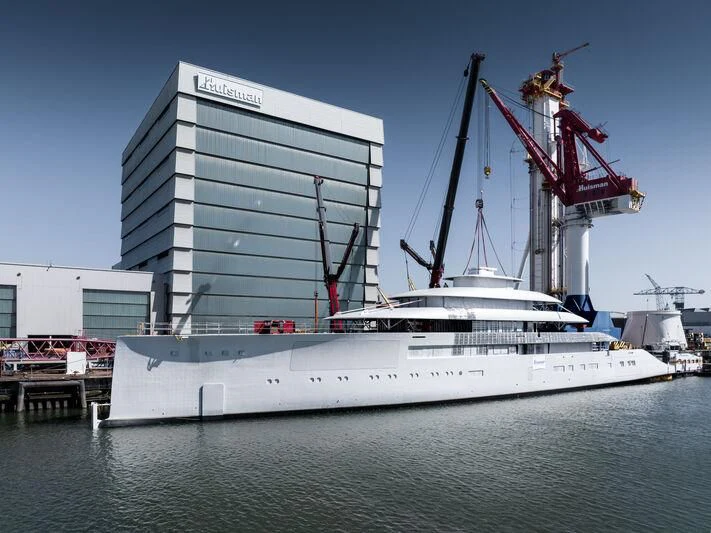a large white boat in a harbor aboard PI Yacht for Sale