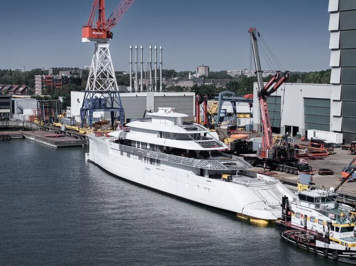 a large white ship in a harbor aboard PI Yacht for Sale