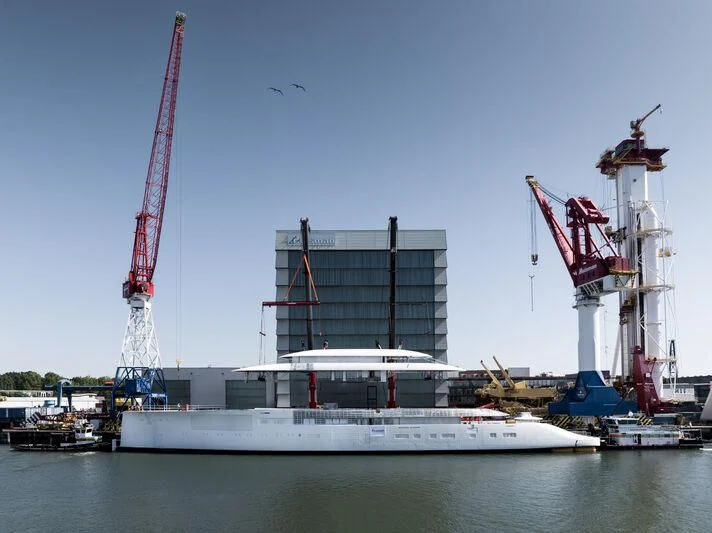 a large white boat in a harbor aboard PI Yacht for Sale