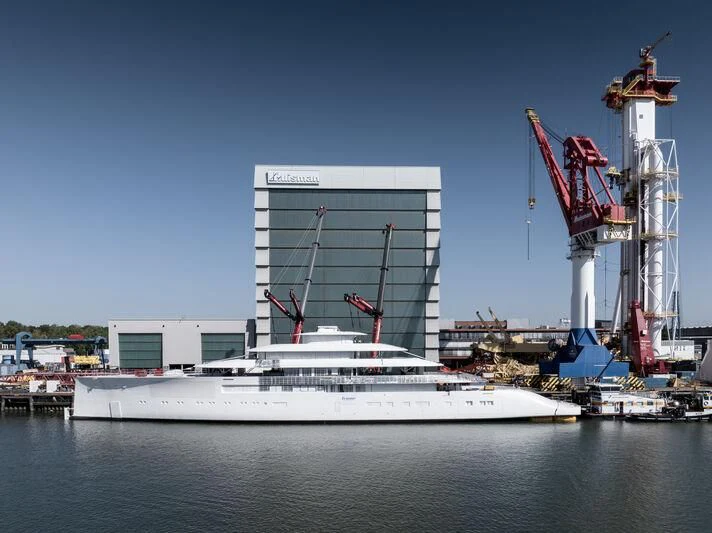 a large white ship in a harbor aboard PI Yacht for Sale