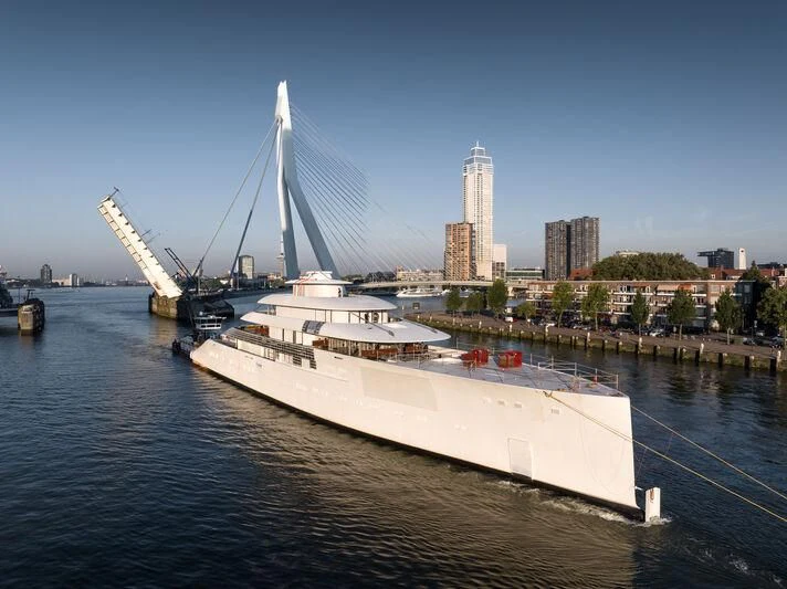 a large white boat in a harbor aboard PI Yacht for Sale