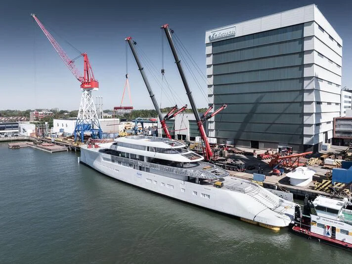 a large white boat in a harbor aboard PI Yacht for Sale