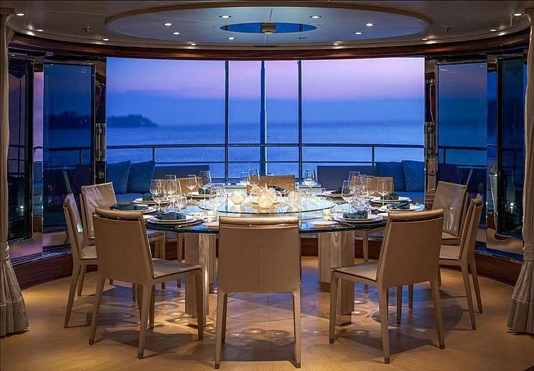 a room with tables and chairs aboard ATLAS Yacht for Sale