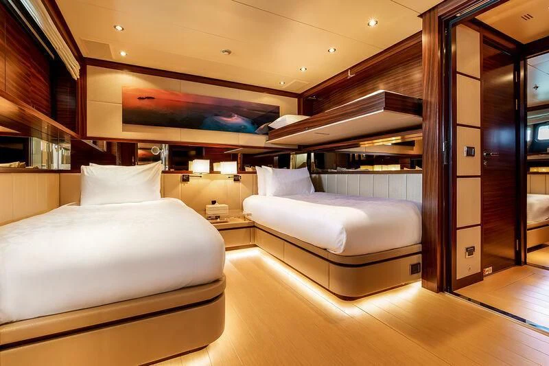 a room with a bed and a couch aboard ATLAS Yacht for Sale