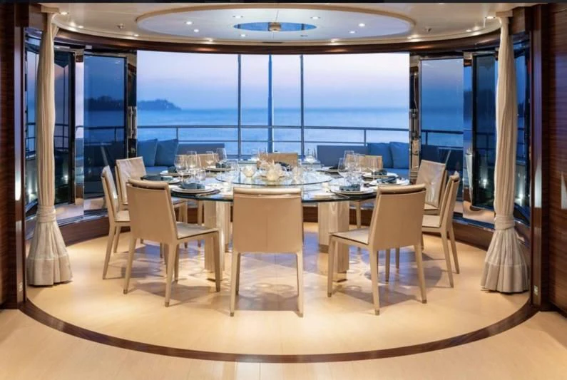 a room with a table and chairs aboard ATLAS Yacht for Sale