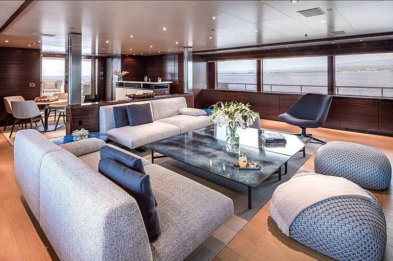 a room with a table chairs and a couch aboard ATLAS Yacht for Sale