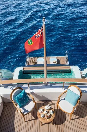a boat with a flag on it aboard LATONA Yacht for Sale