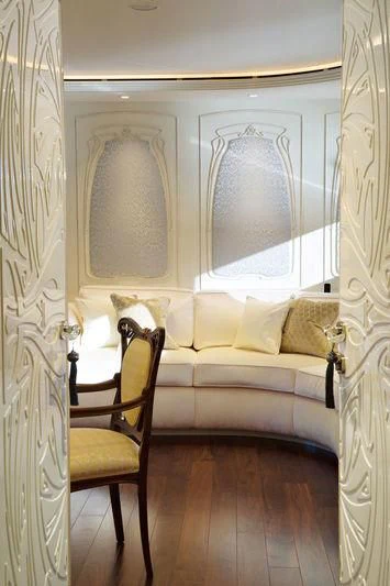 a room with a bed and a chair aboard LATONA Yacht for Sale