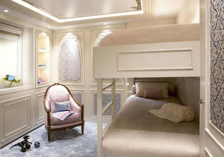 a room with a bed and a chair aboard LATONA Yacht for Sale