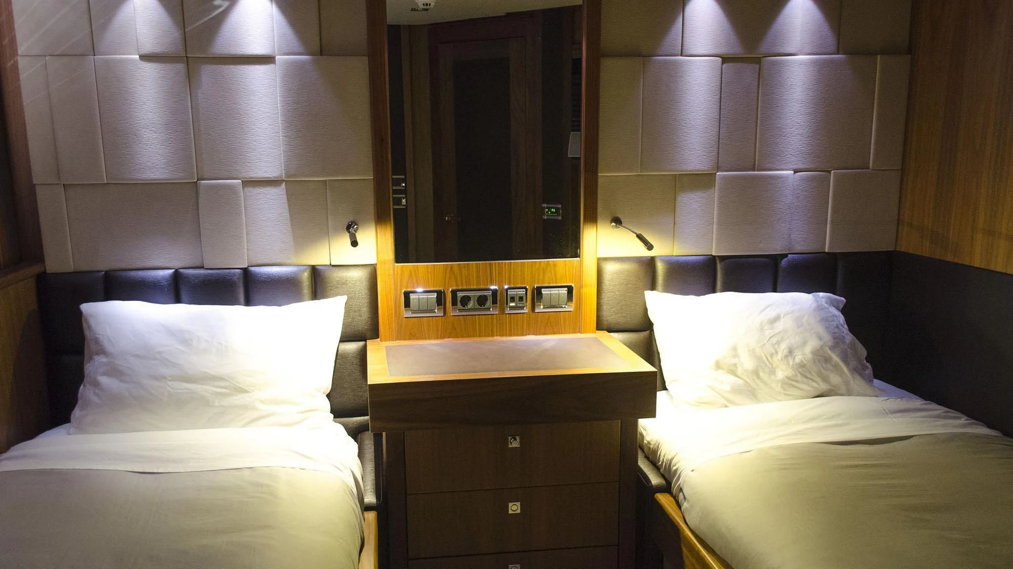 a room with a bed and a mirror aboard LATONA Yacht for Sale