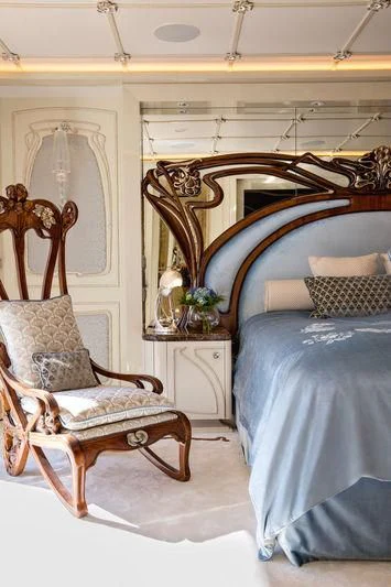a bedroom with a blue bed aboard LATONA Yacht for Sale