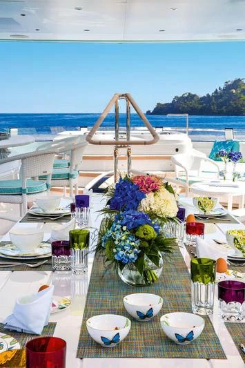 a table set with flowers and candles aboard LATONA Yacht for Sale