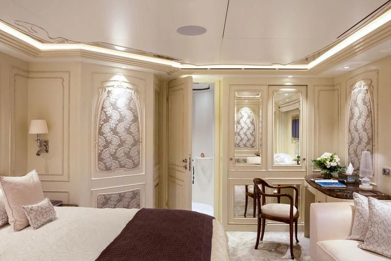 a bedroom with a bed and a chair aboard LATONA Yacht for Sale