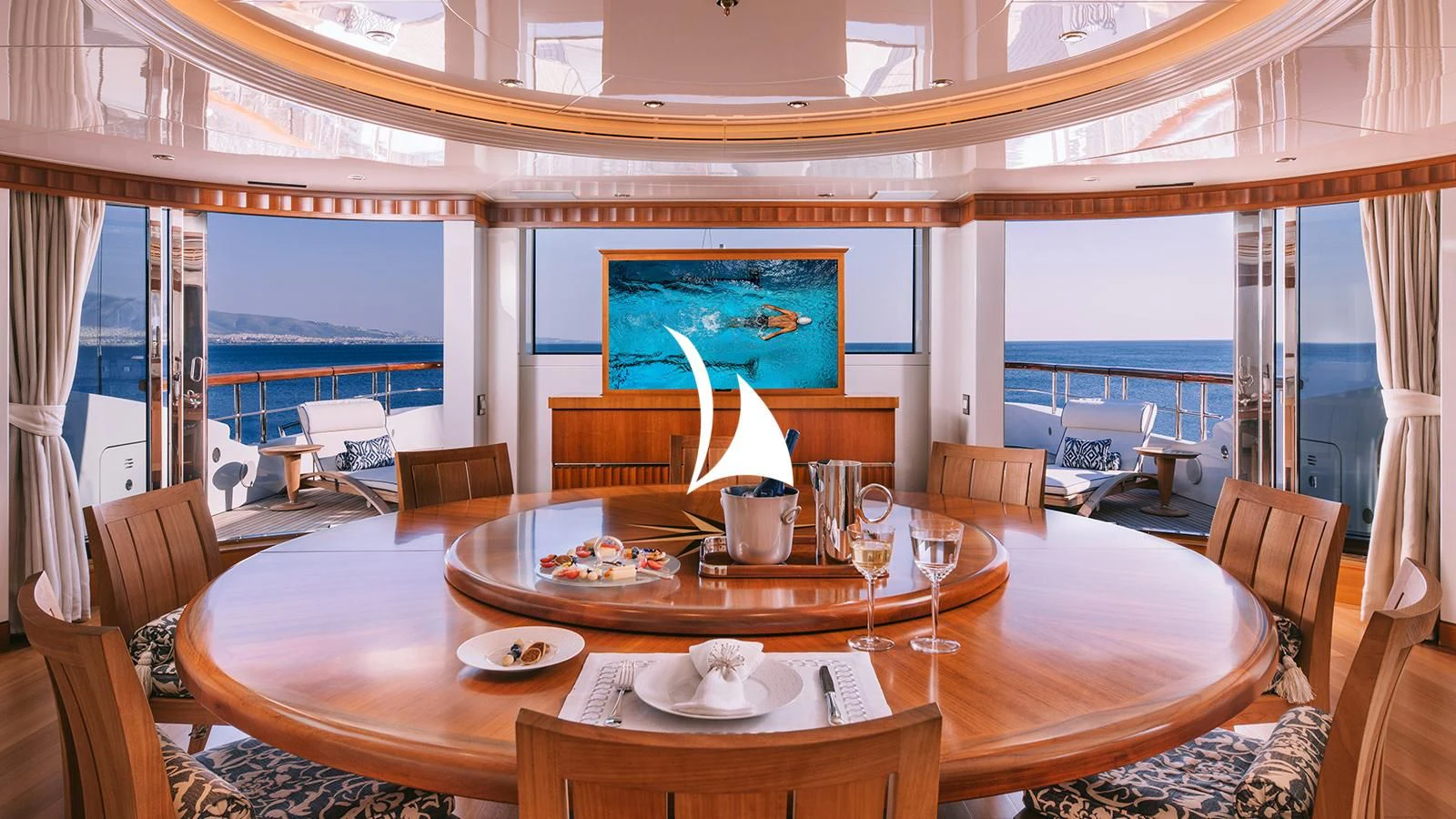 a dining table with a view of the ocean aboard AELIA Yacht for Sale