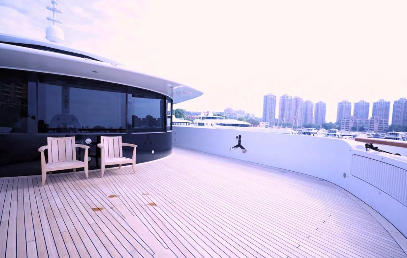 a person sitting on a deck overlooking a body of water aboard AELIA Yacht for Sale