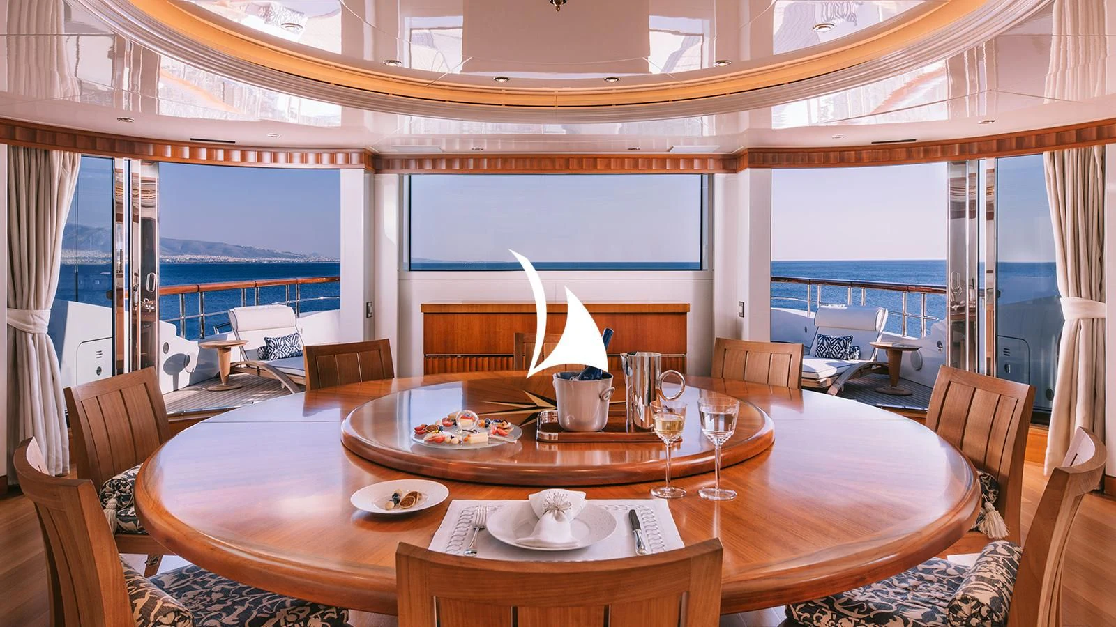 a dining table with a view of the ocean aboard AELIA Yacht for Sale