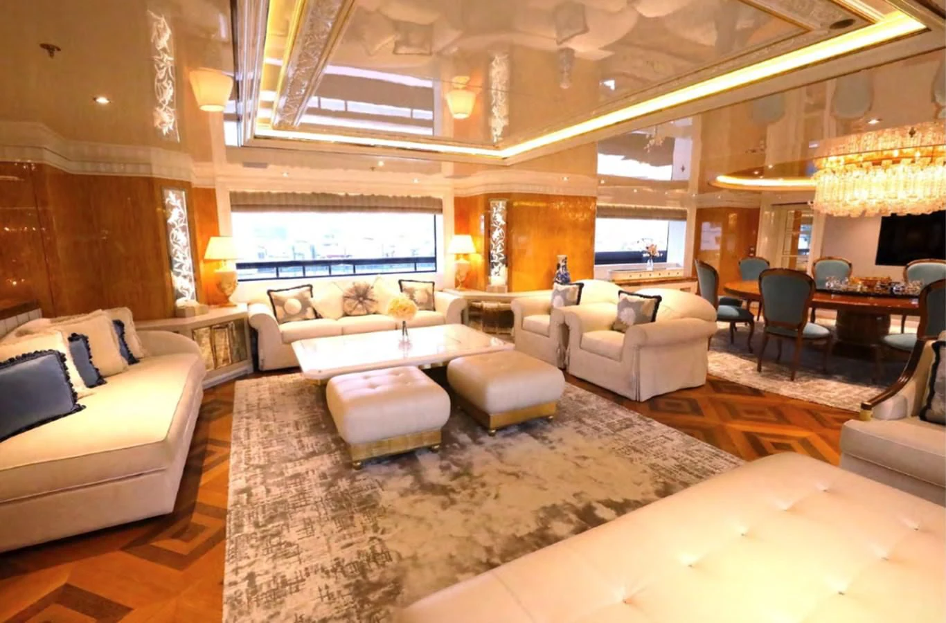 a living room with a large chandelier aboard AELIA Yacht for Sale