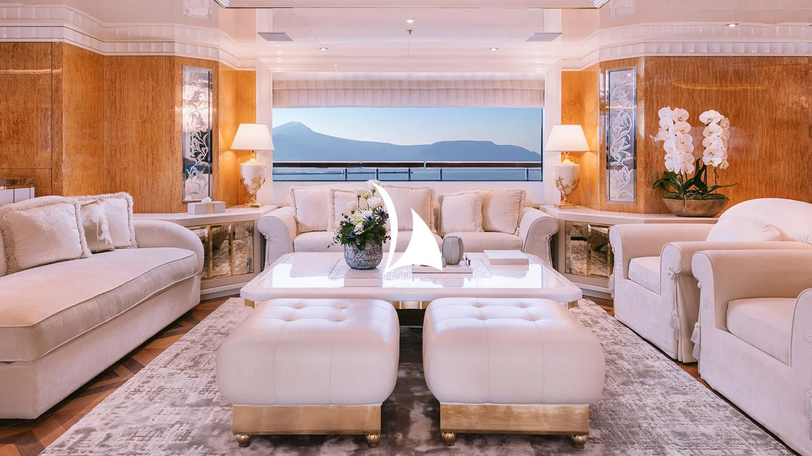 a living room with a white couch and a table aboard AELIA Yacht for Sale