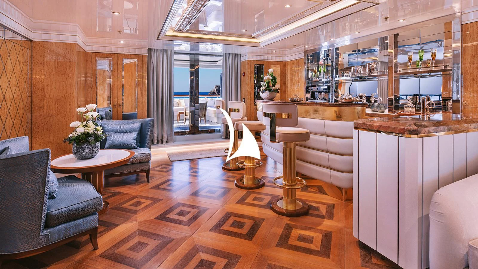 a room with a table chairs and a couch aboard AELIA Yacht for Sale