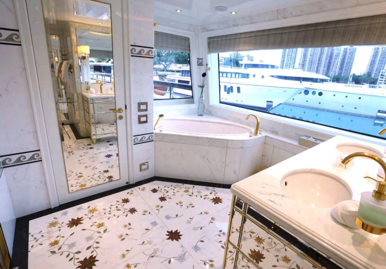 a bathroom with a tub sink and a sink aboard AELIA Yacht for Sale