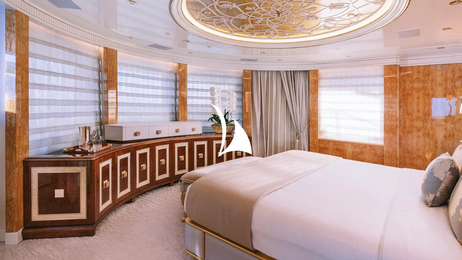 a bedroom with a bed and a fireplace aboard AELIA Yacht for Sale