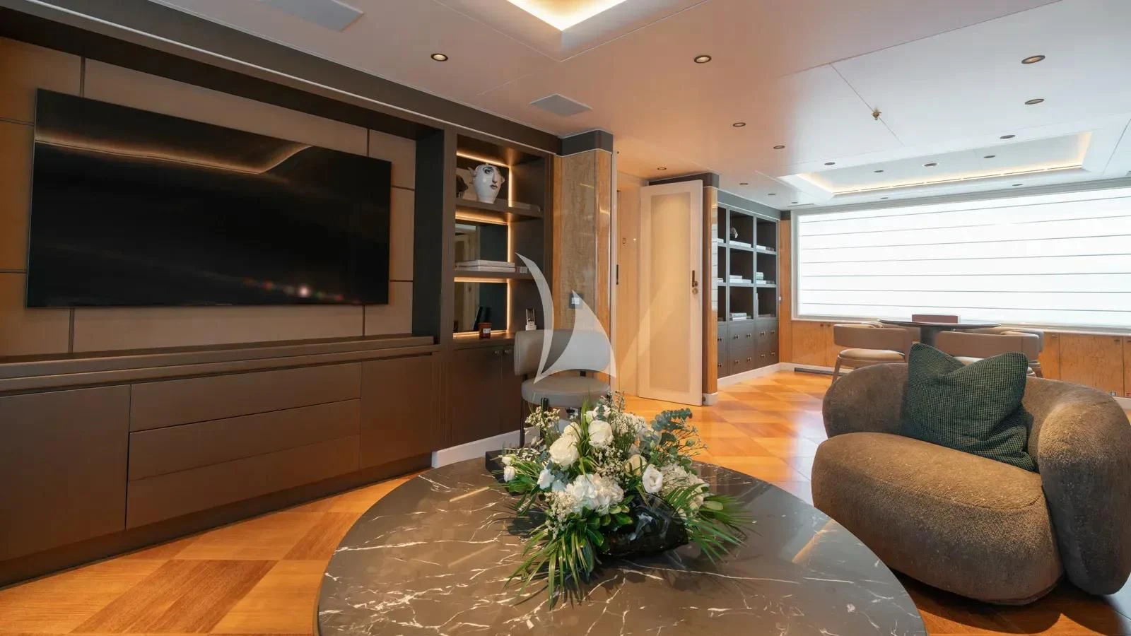 a living room with a large television aboard AELIA Yacht for Sale