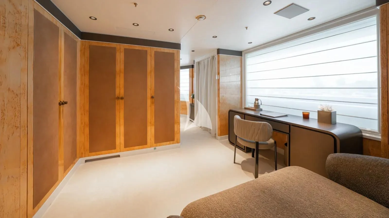 a room with a bed and desk aboard AELIA Yacht for Sale