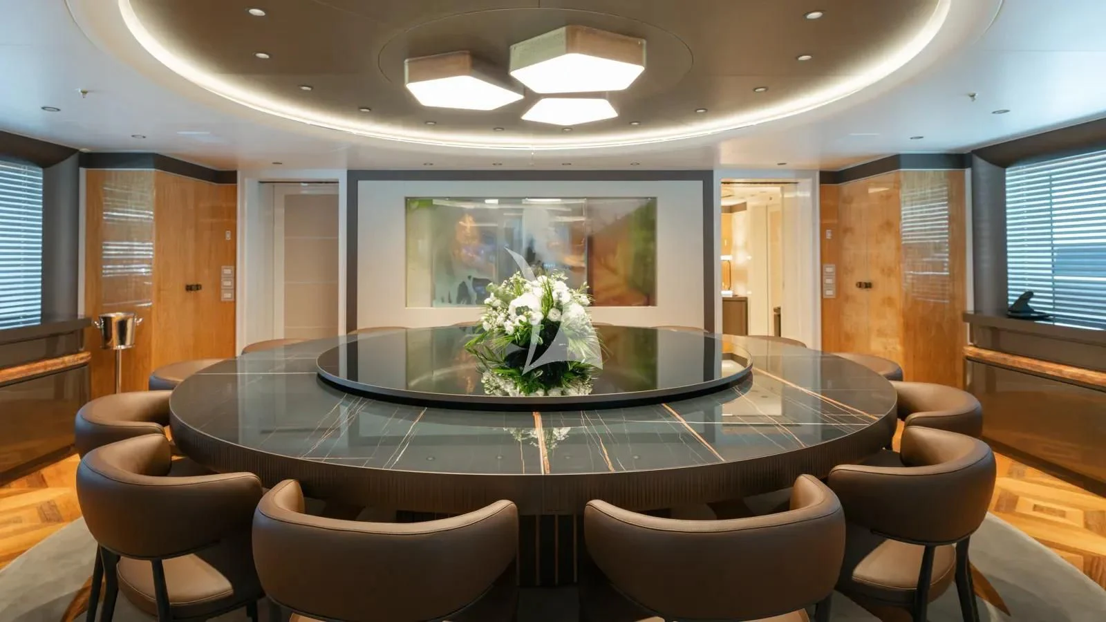 a large room with a large table and chairs and a large fish tank aboard AELIA Yacht for Sale