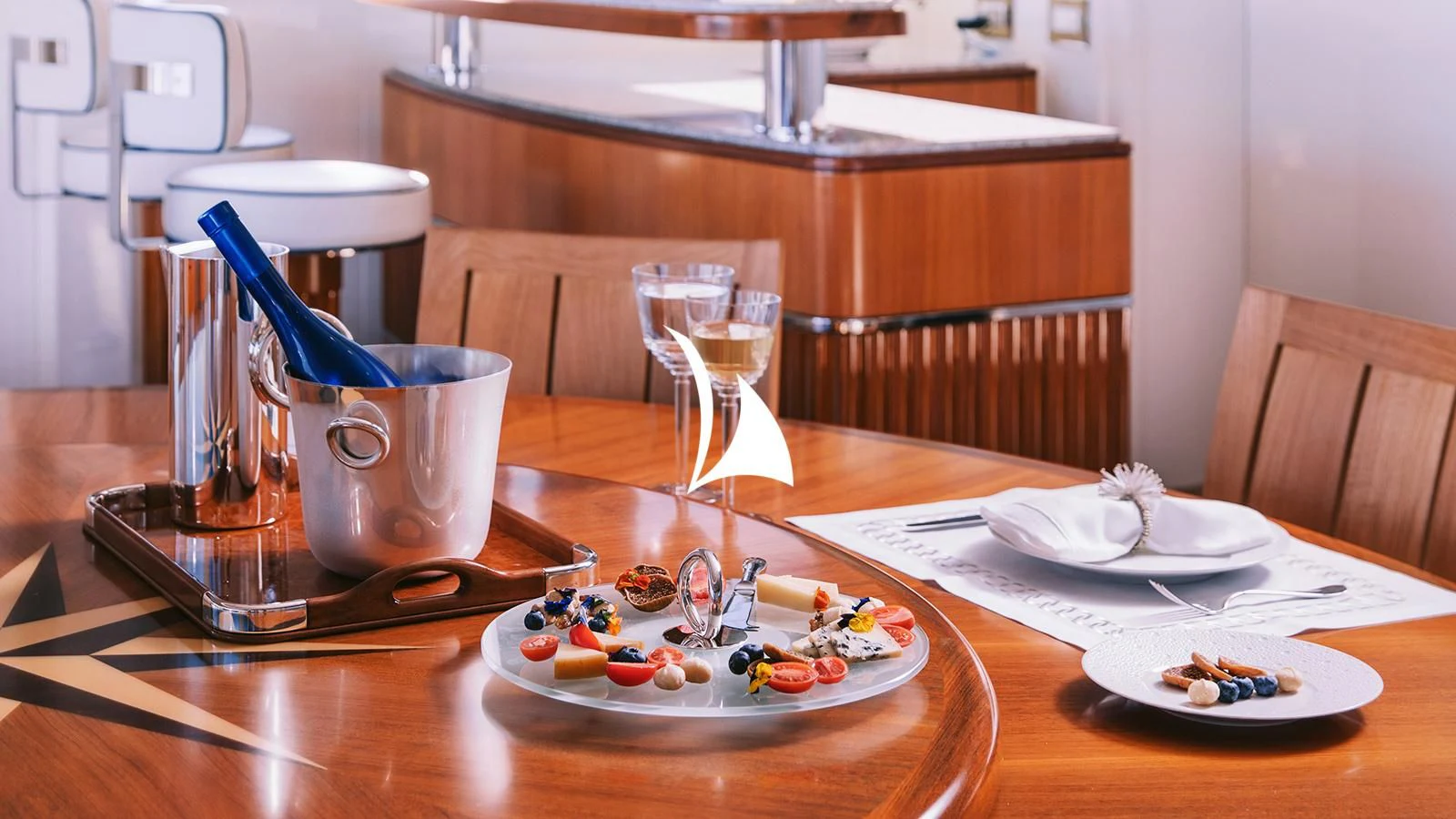 a table with plates and glasses aboard AELIA Yacht for Sale