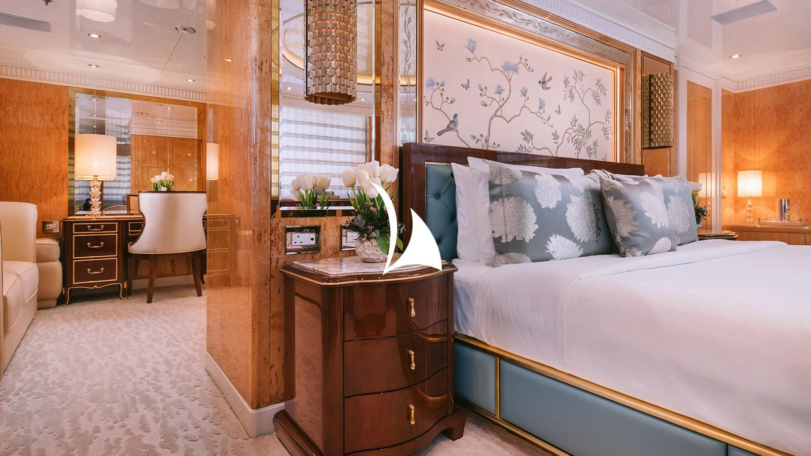 a bedroom with a bed and a desk aboard AELIA Yacht for Sale