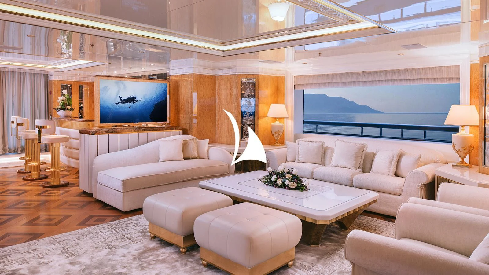 a living room with a large screen aboard AELIA Yacht for Sale