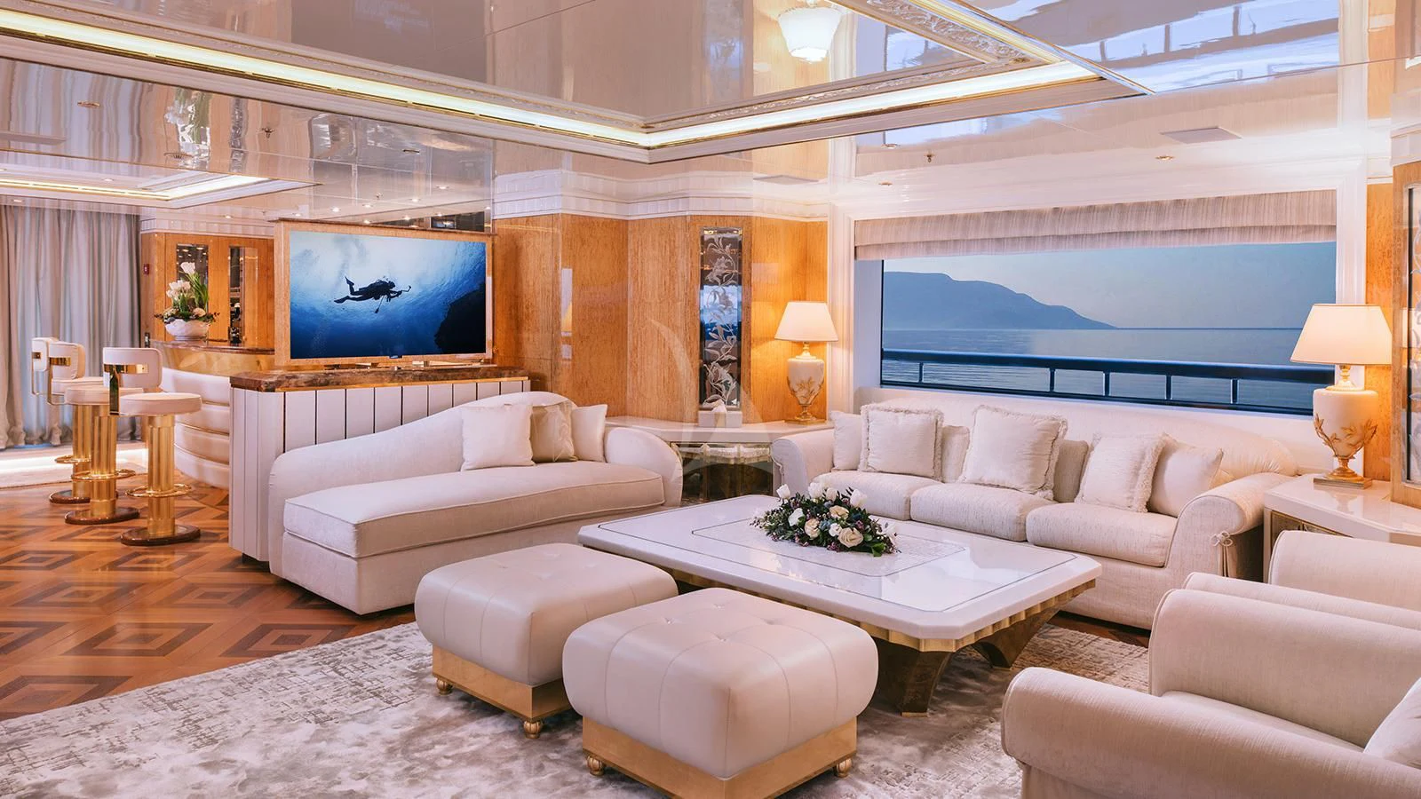 a living room with a large screen aboard AELIA Yacht for Sale