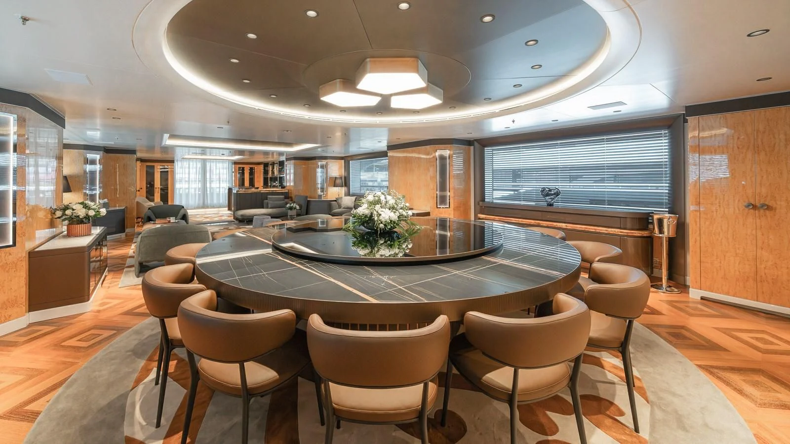a large room with a table and chairs aboard AELIA Yacht for Sale