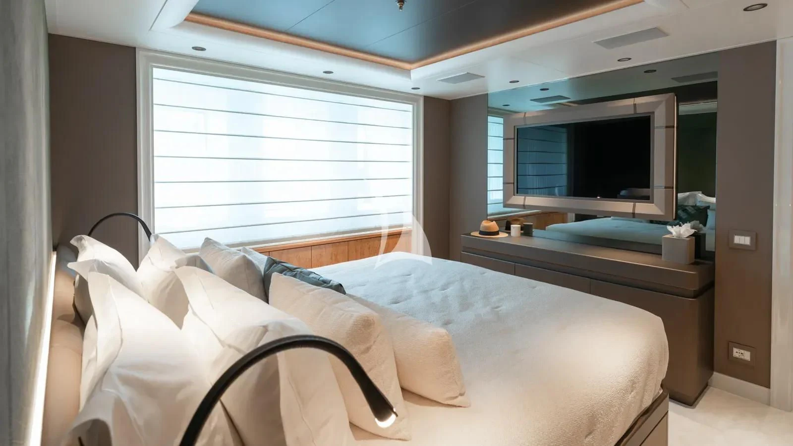 a room with a bed and a television aboard AELIA Yacht for Sale