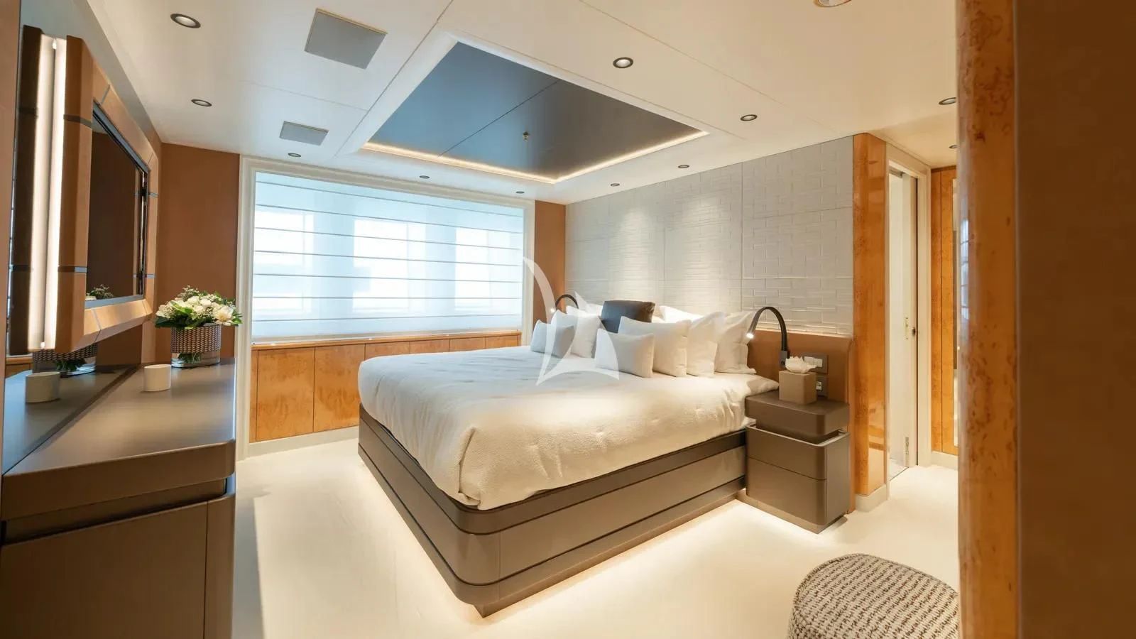 a bedroom with a bed and a desk aboard AELIA Yacht for Sale