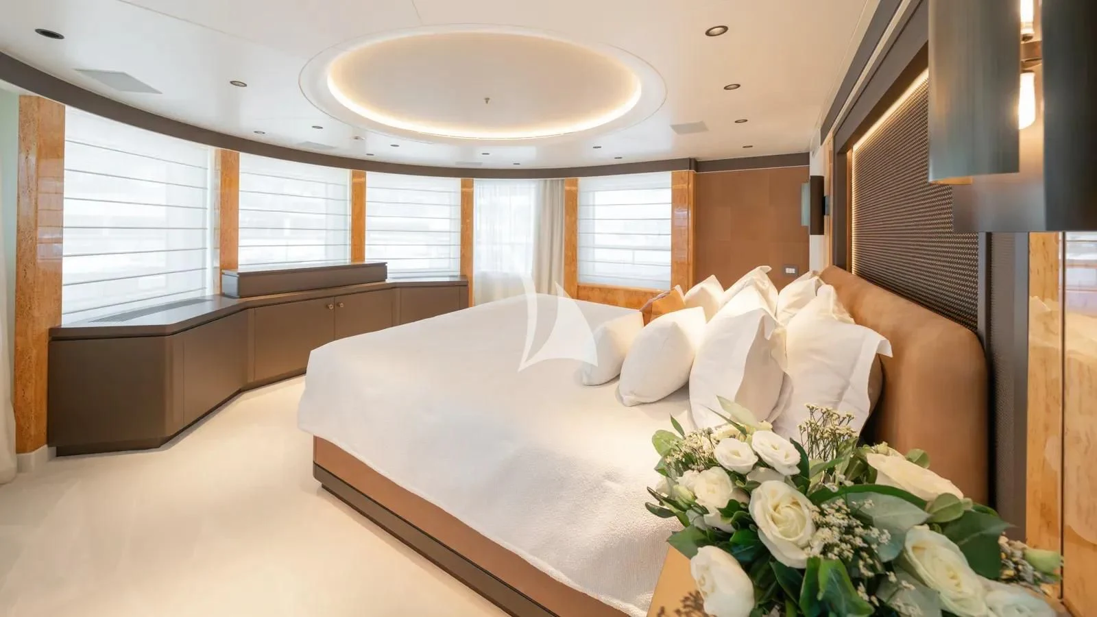 a hotel room with a bed and flowers aboard AELIA Yacht for Sale