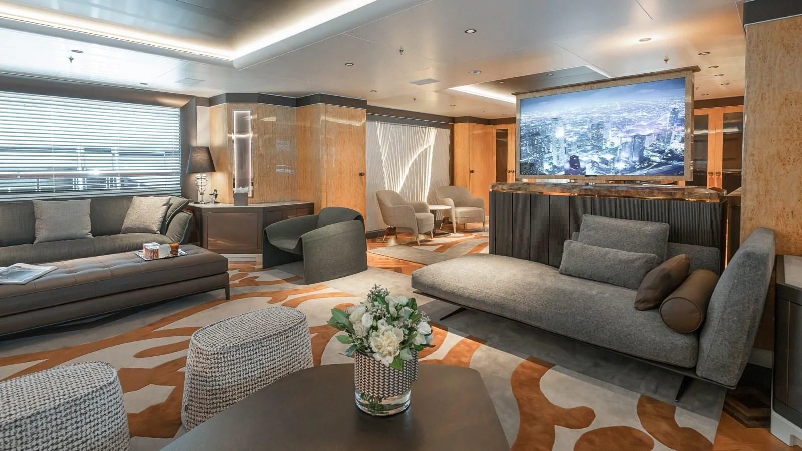 a living room with a large screen aboard AELIA Yacht for Sale