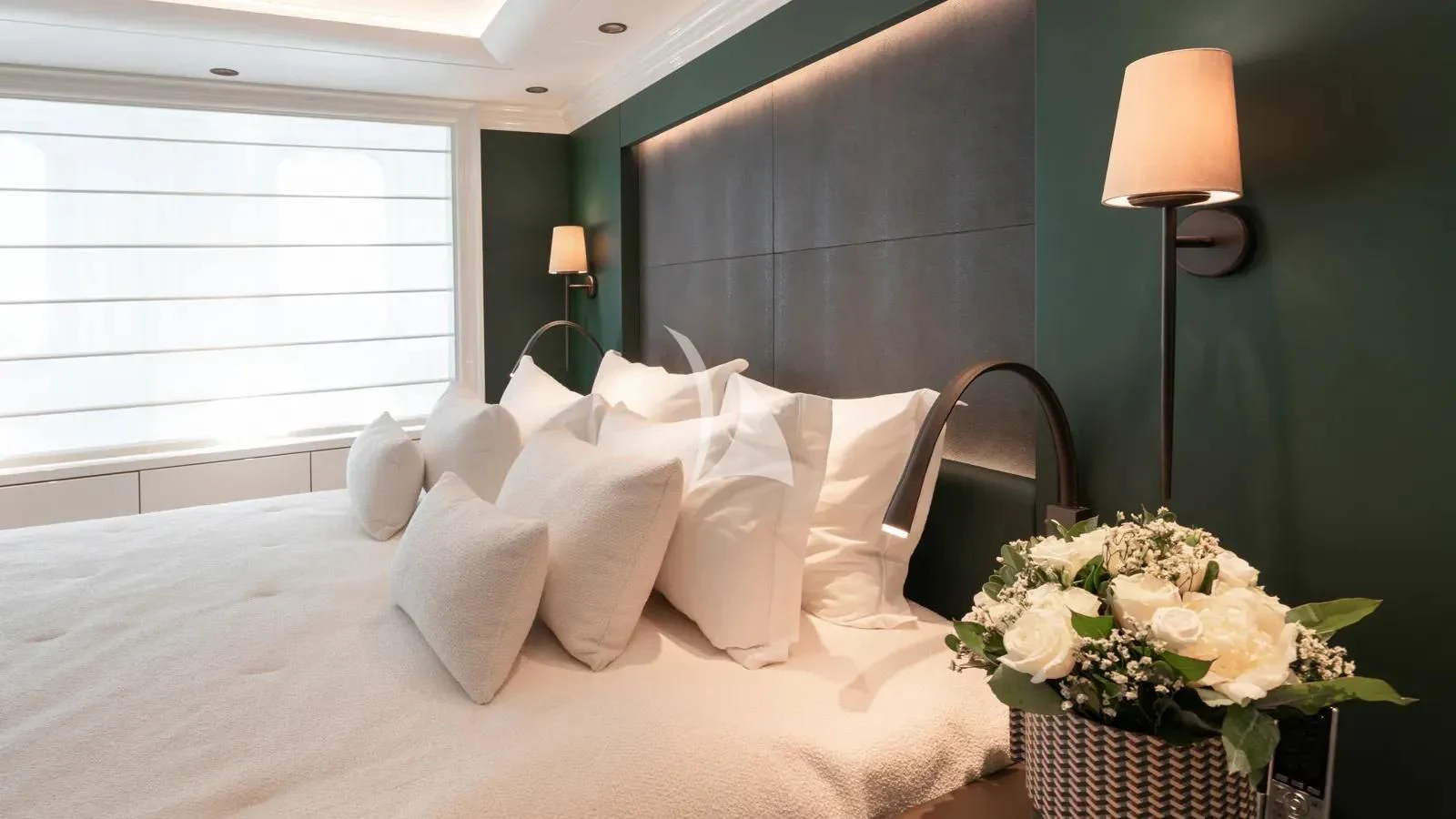 a bed with white pillows and white sheets aboard AELIA Yacht for Sale
