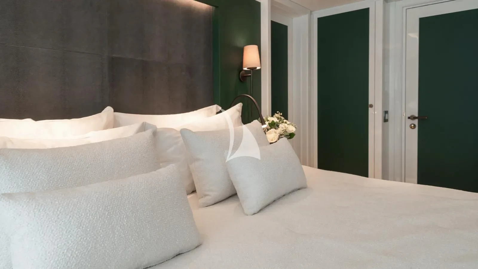 a bed with white pillows aboard AELIA Yacht for Sale